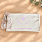 Vista frontal del neceser solidario Singular con corazón rosa y lazo floral